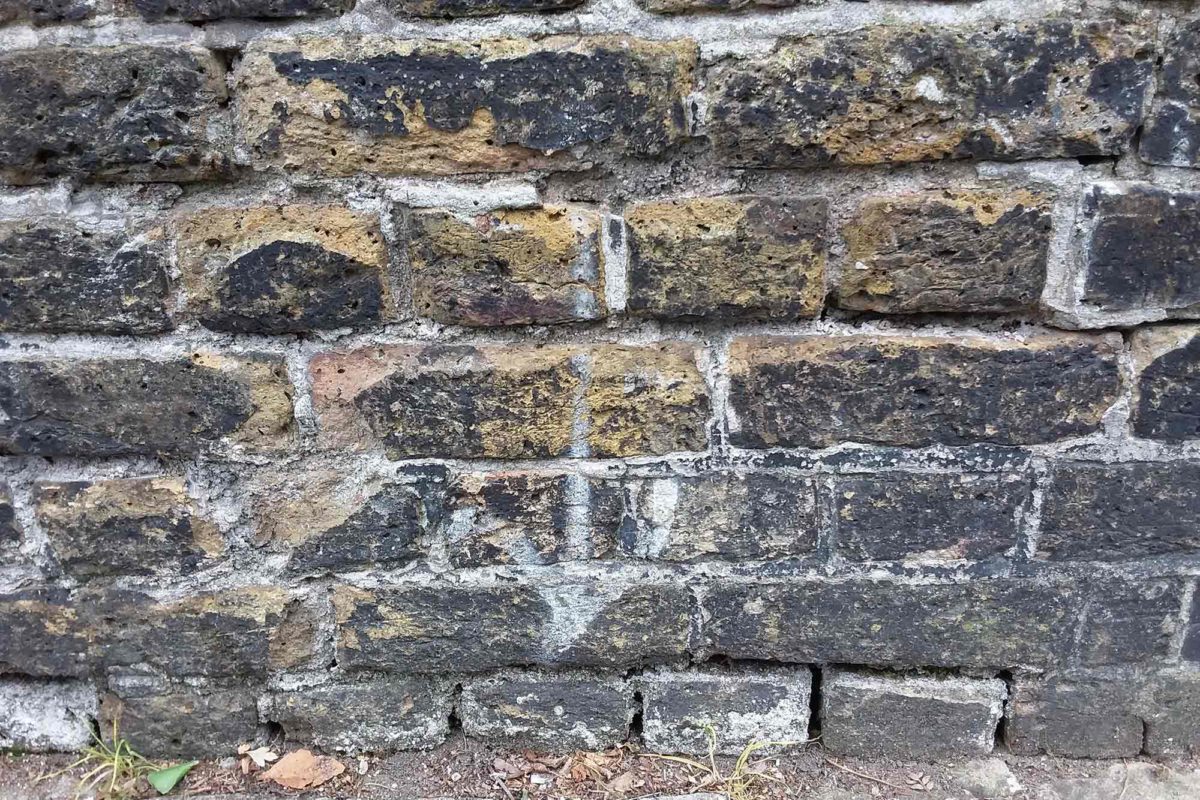 brick wall with white arrow